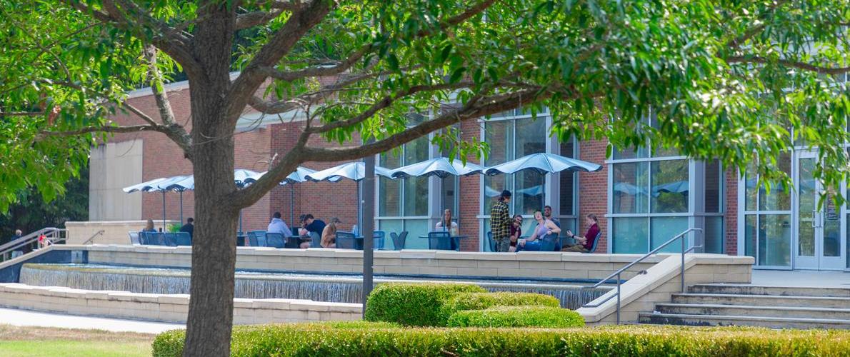 students sitting in front of morris library